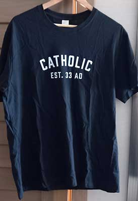 Picture of navey blue tee-shirt with Catholic Est. 33AD printed on the front
